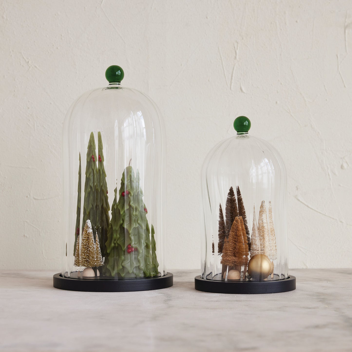 Fluted glass cloche with green knob handle and MDF base, shown in two sizes, ideal for plants, seasonal vignettes, or timeless home décor.