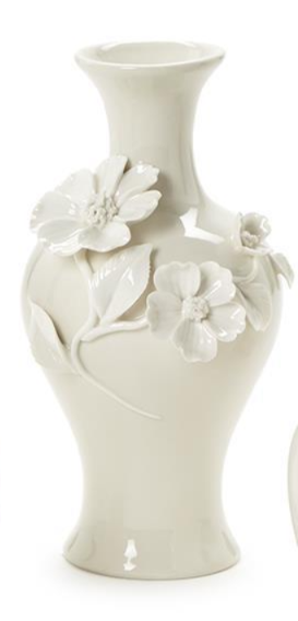 White ceramic vase with floral designs on a white background