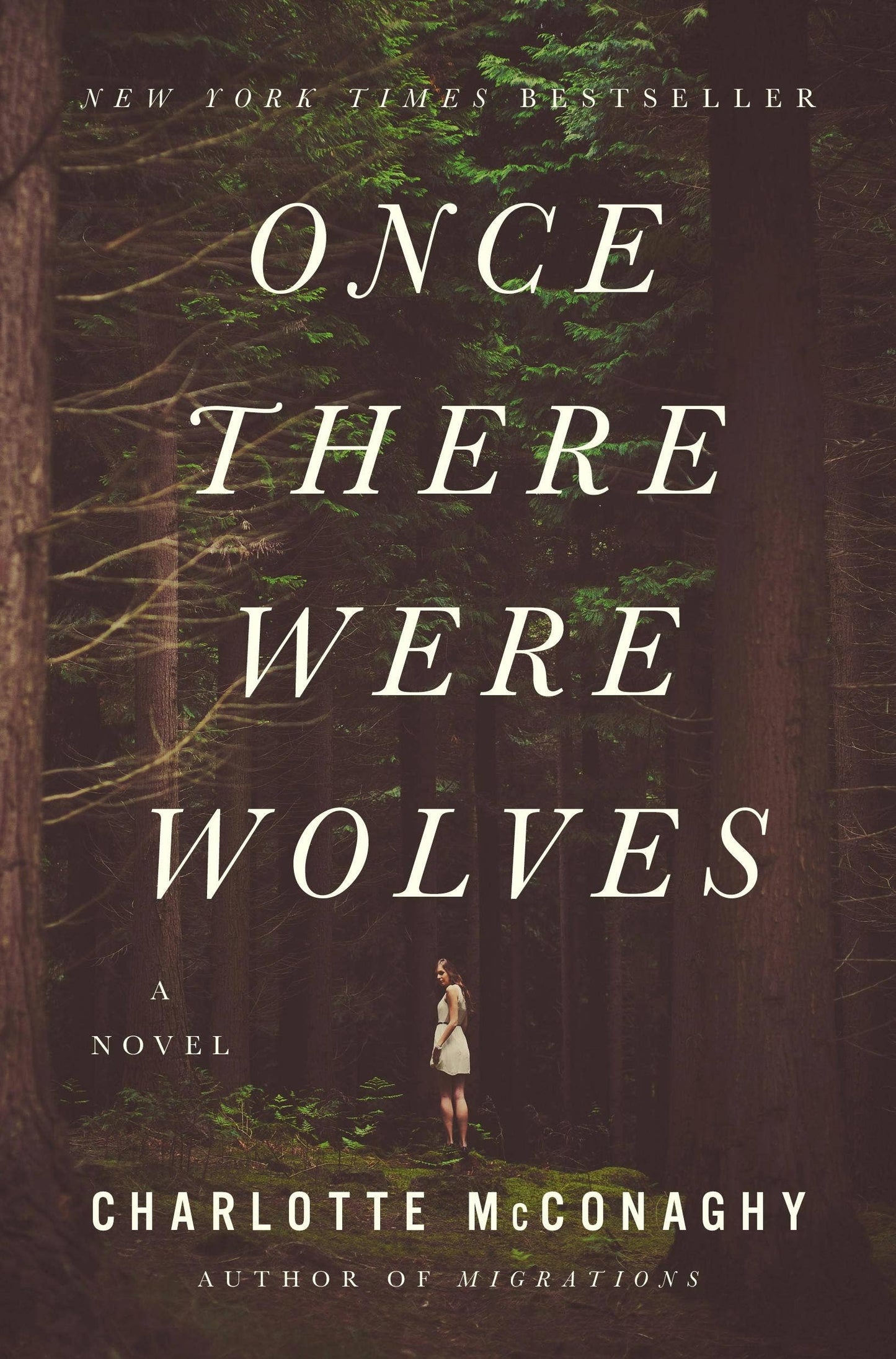 Book cover of 'Once There Were Wolves' by Charlotte McConaghy with a forest background.