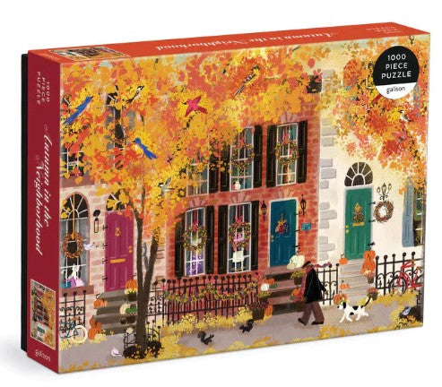 Puzzle box with autumn-themed design of a street scene and colorful leaves.