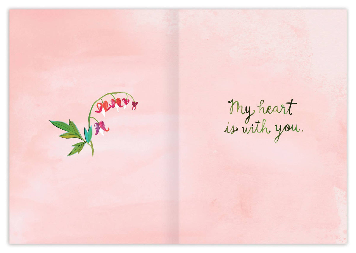 Open book with floral design and text on a pink background