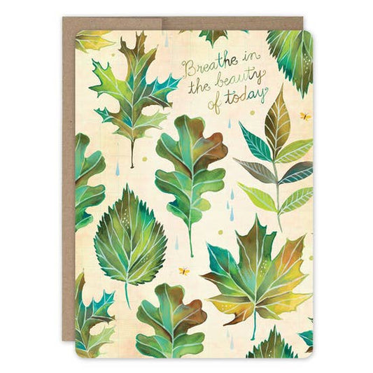 Greeting card with leaf pattern and text 'Breathe in the beauty of today' on a beige background.