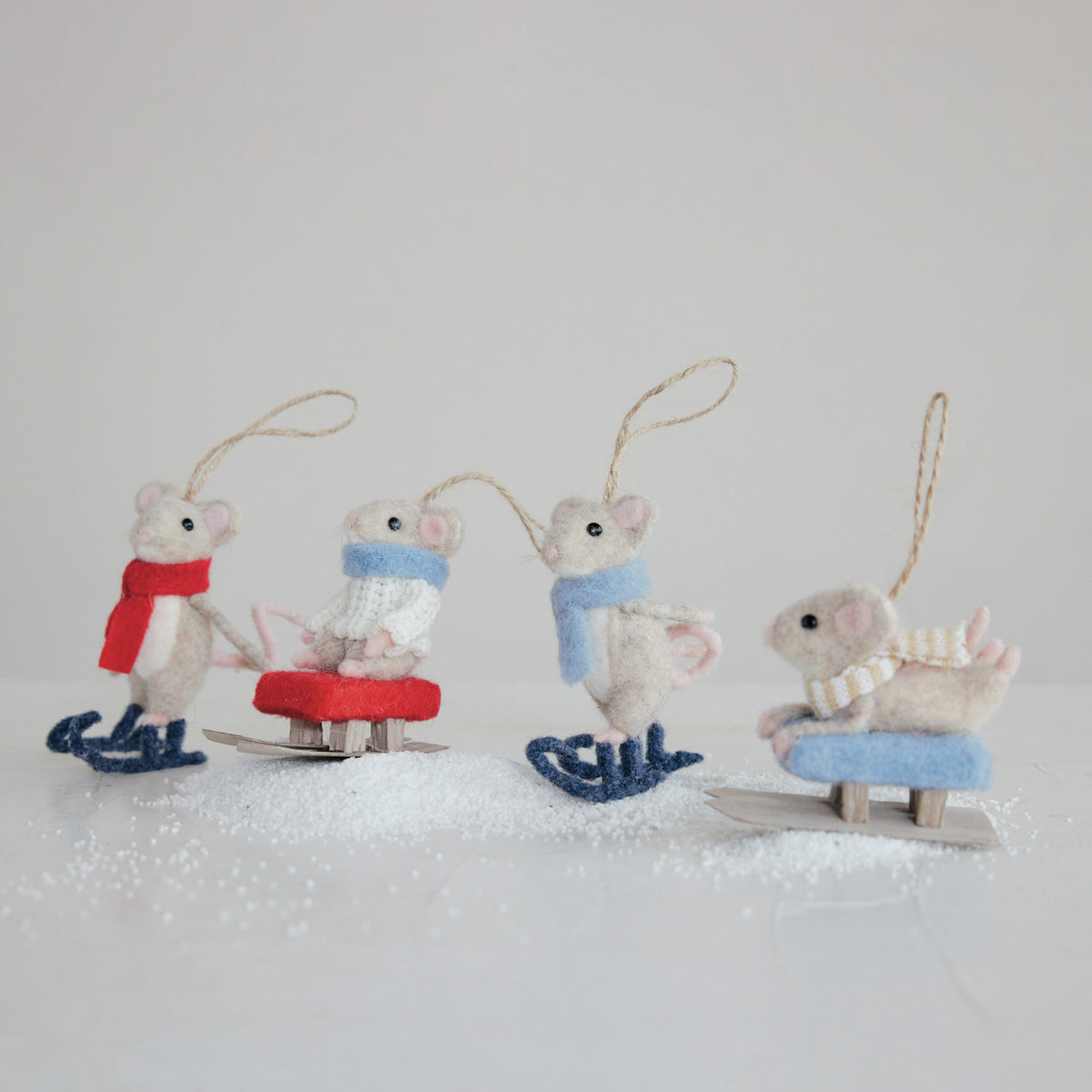 Set of four decorative mouse ornaments on a white background