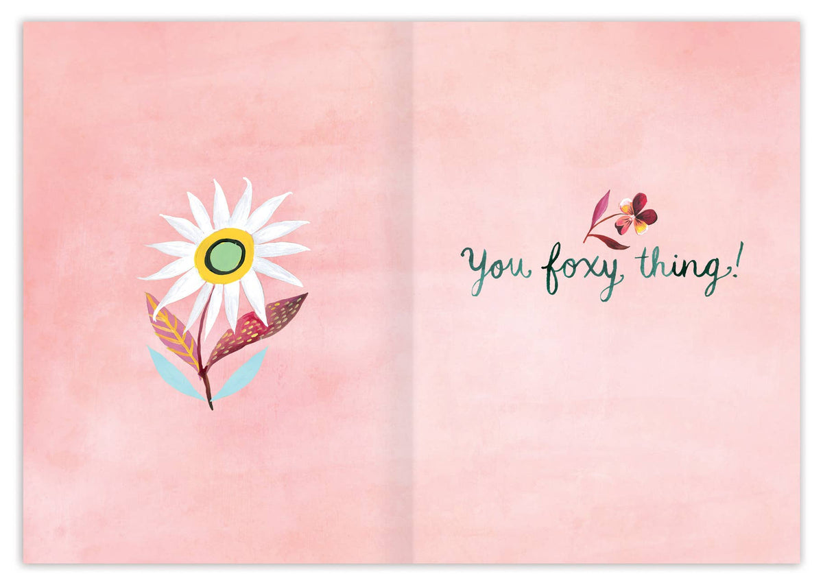 Open book with a floral illustration and text on a pink background