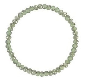 A beaded stretch bracelet made of small, faceted light green beads, arranged in a circular shape against a plain white background.