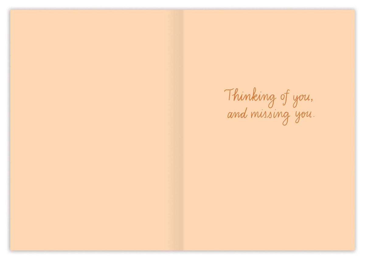 Open card with 'Thinking of you, and missing you' text on a peach background