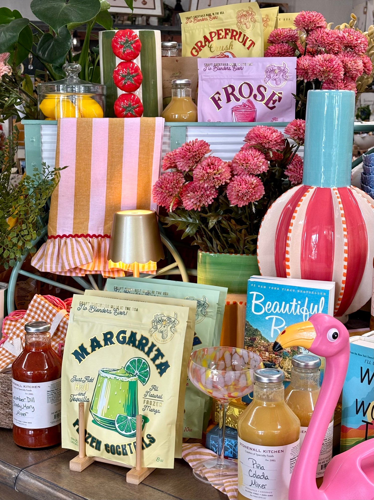 Decorative items including a pink flamingo, bottles, and a 'Margarita' drink mix on a table.
