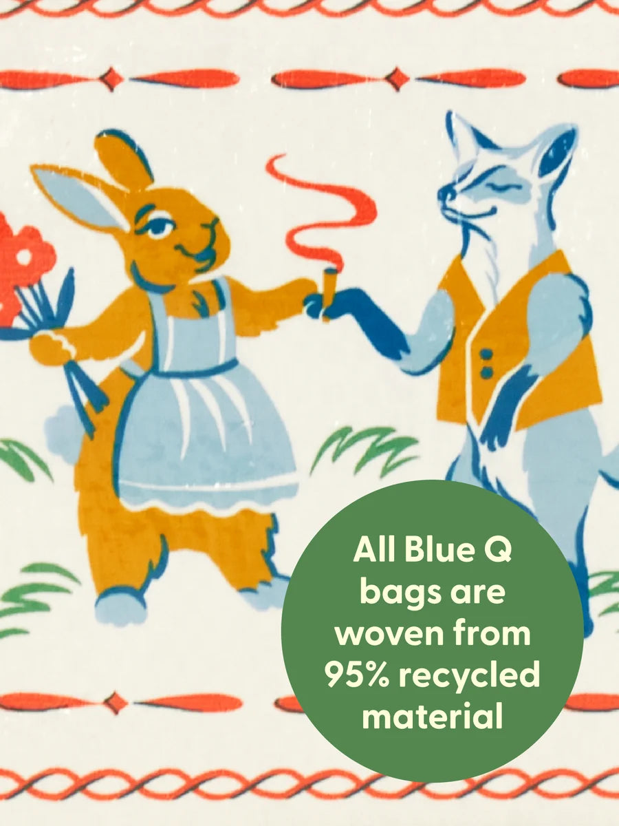 A close-up of a patterned fabric featuring a retro illustration of a rabbit in a blue dress and a fox in a yellow vest holding hands, with a green circular text overlay that reads 'All Blue Q bags are woven from 95% recycled material'.