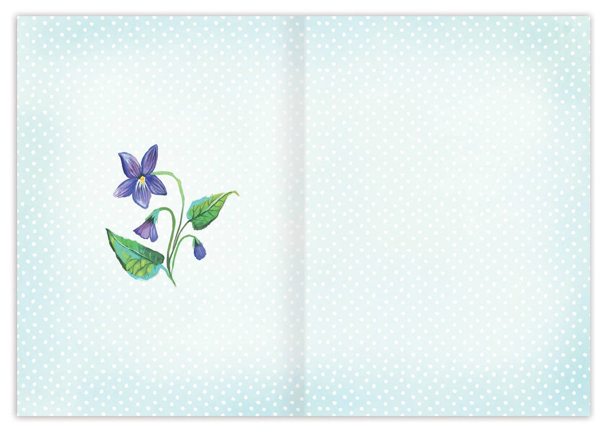 card with floral design on a light blue polka dot background