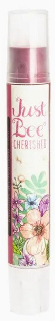 Floral lip shimmer labeled 'Just Bee Cherished' with colorful design