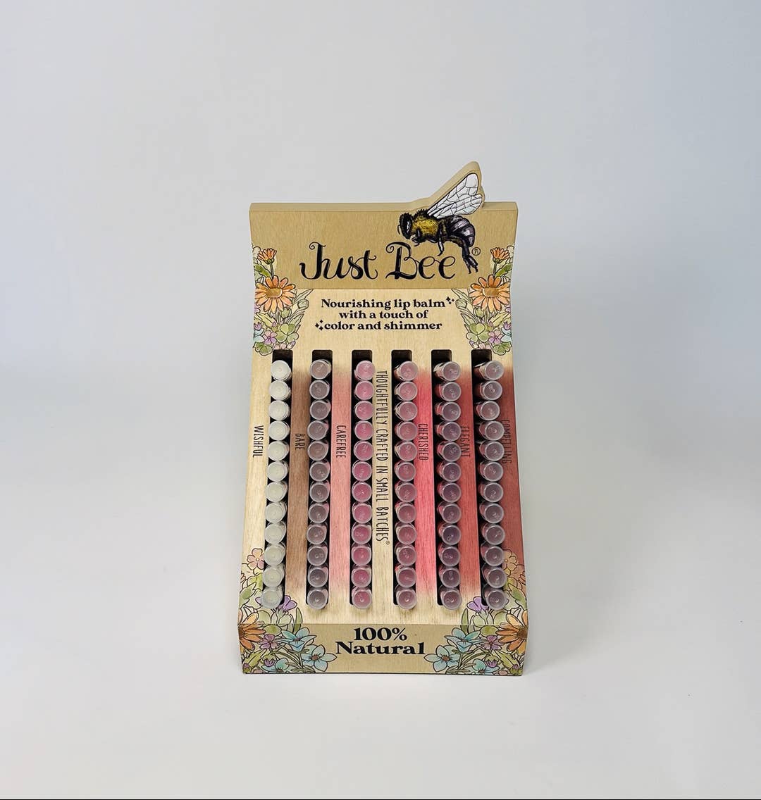 Packaged lip balm set with 'Just Bee' branding on a light gray background
