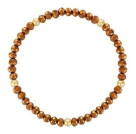 A beaded stretch bracelet featuring faceted brown beads and a few small gold spacer beads, shown on a plain white background.