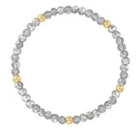 A beaded stretch bracelet featuring faceted gray beads and three small polished gold accent beads, displayed on a clean white background.