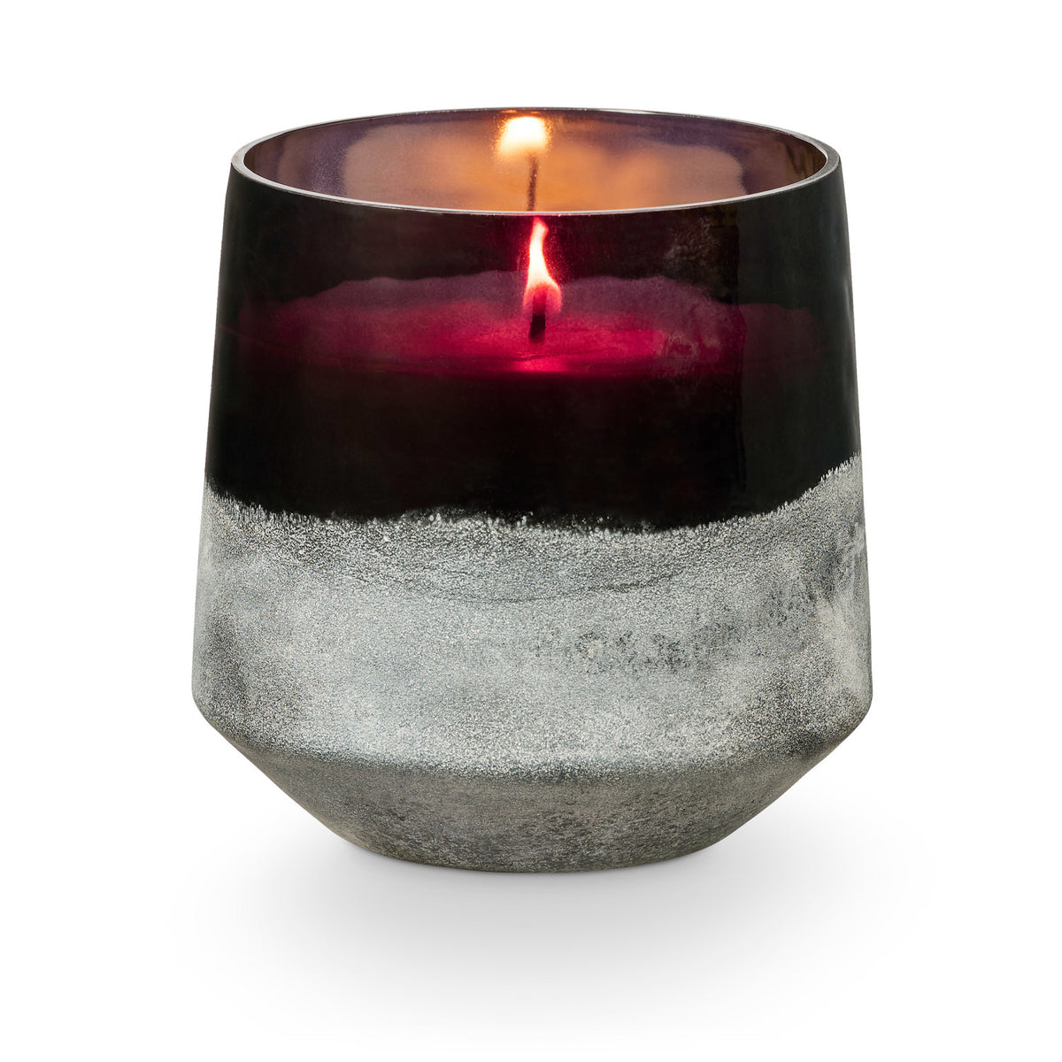 Candle in a black and gray glass container on a white background