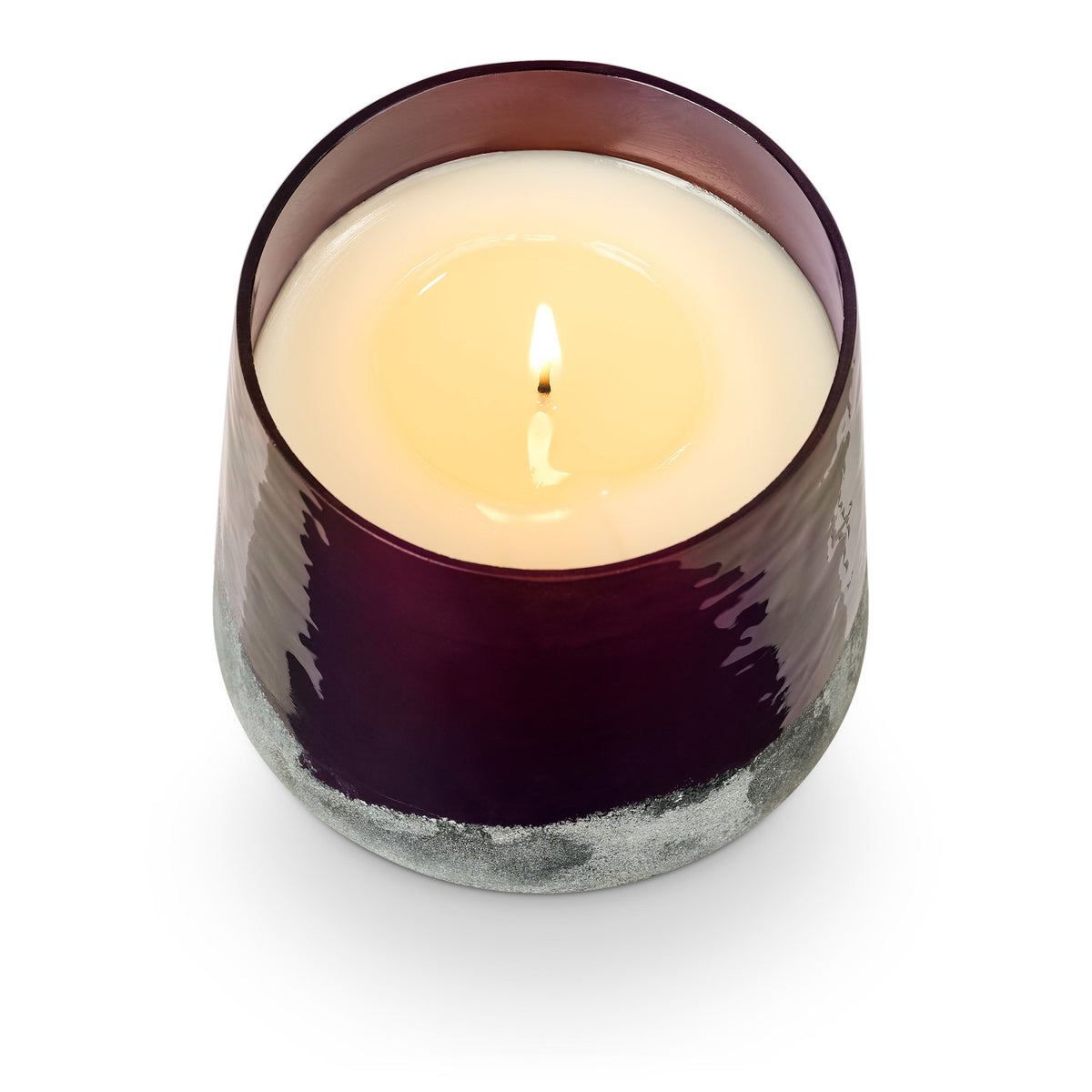 Candle in a textured purple container on a white background