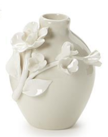 White ceramic vase with floral decorations on a white background