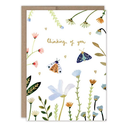 Greeting card with floral design and 'thinking of you' text on a white background