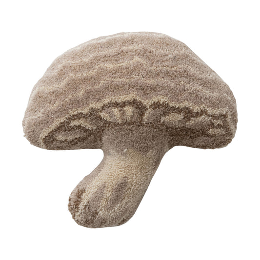 Wool tufted mushroom-shaped pillow in cream with beige and brown details, styled in a cozy woodland-inspired setting.