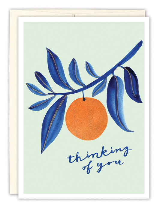 Greeting card with an orange and blue leaves on a light green background