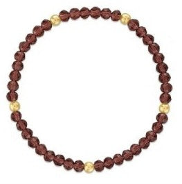 A beaded stretch bracelet featuring dark garnet purple faceted beads and small metallic gold spacer beads, shown on a plain white background.