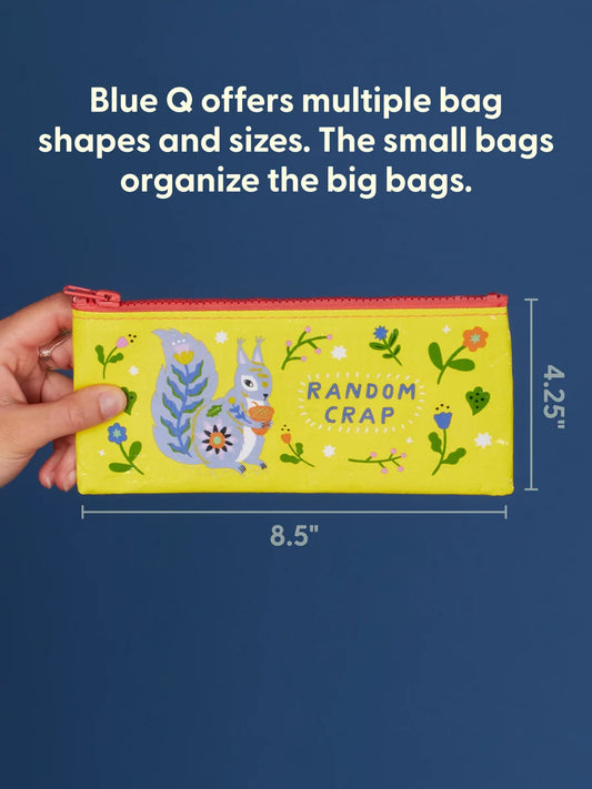 A hand holds a bright yellow zip pouch with a colorful squirrel illustration and the words 'RANDOM CRAP' against a dark blue background. White text at the top says Blue Q offers multiple bag shapes and sizes.