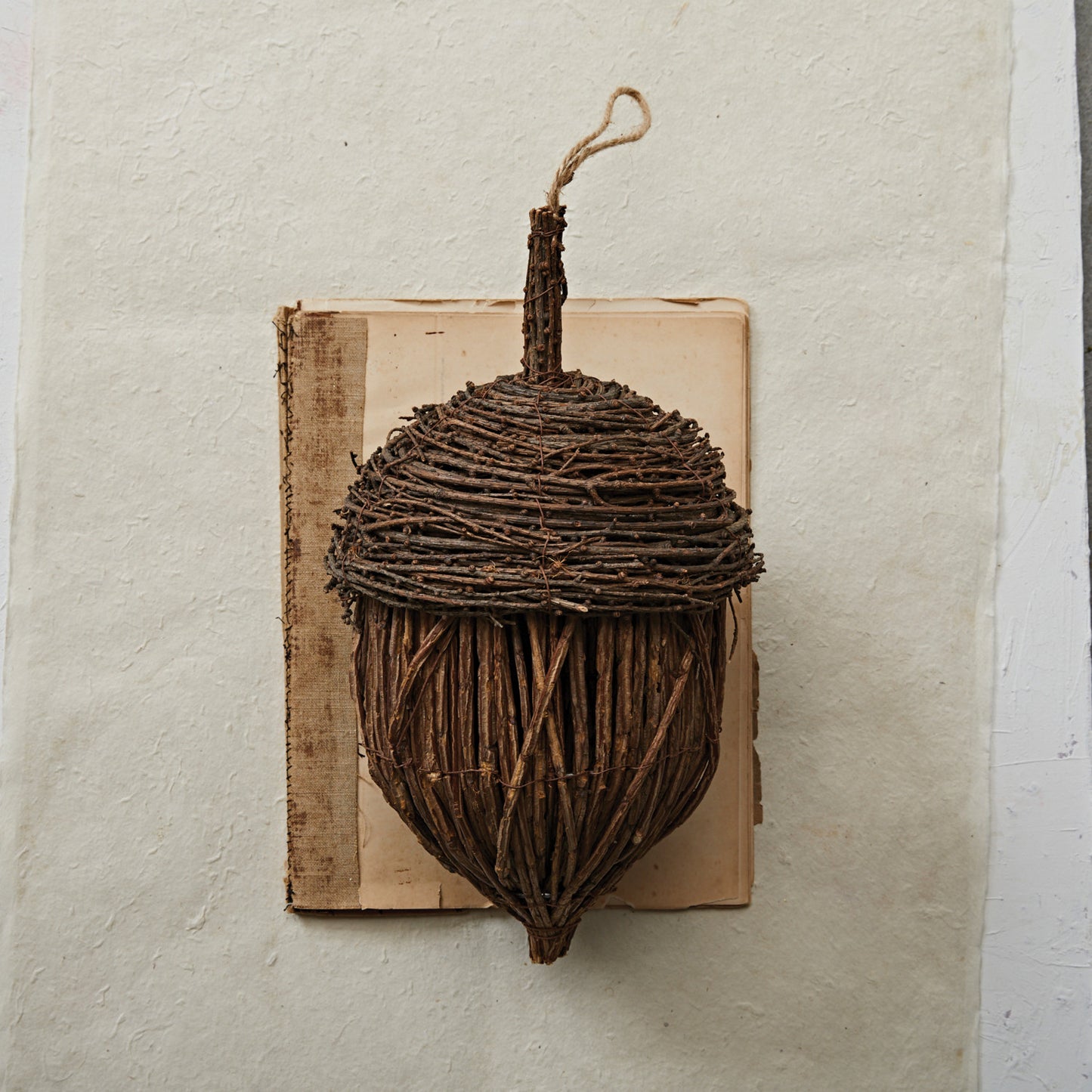 Large 13-inch rattan acorn décor piece with handcrafted texture, styled on a mantel with fall accents.