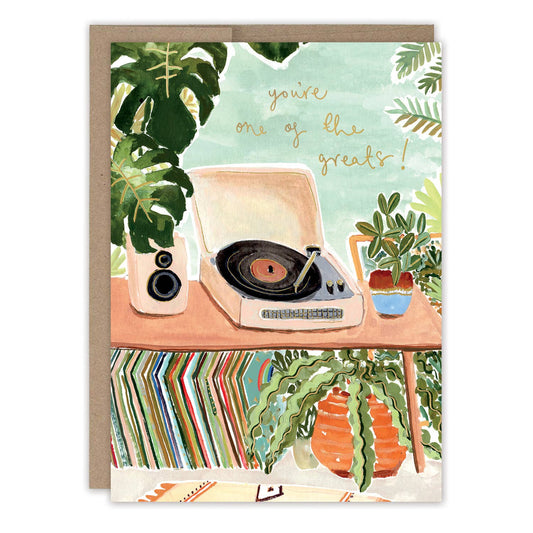 Greeting card with a record player and plants on a table, featuring the text 'you're one of the greats!'.