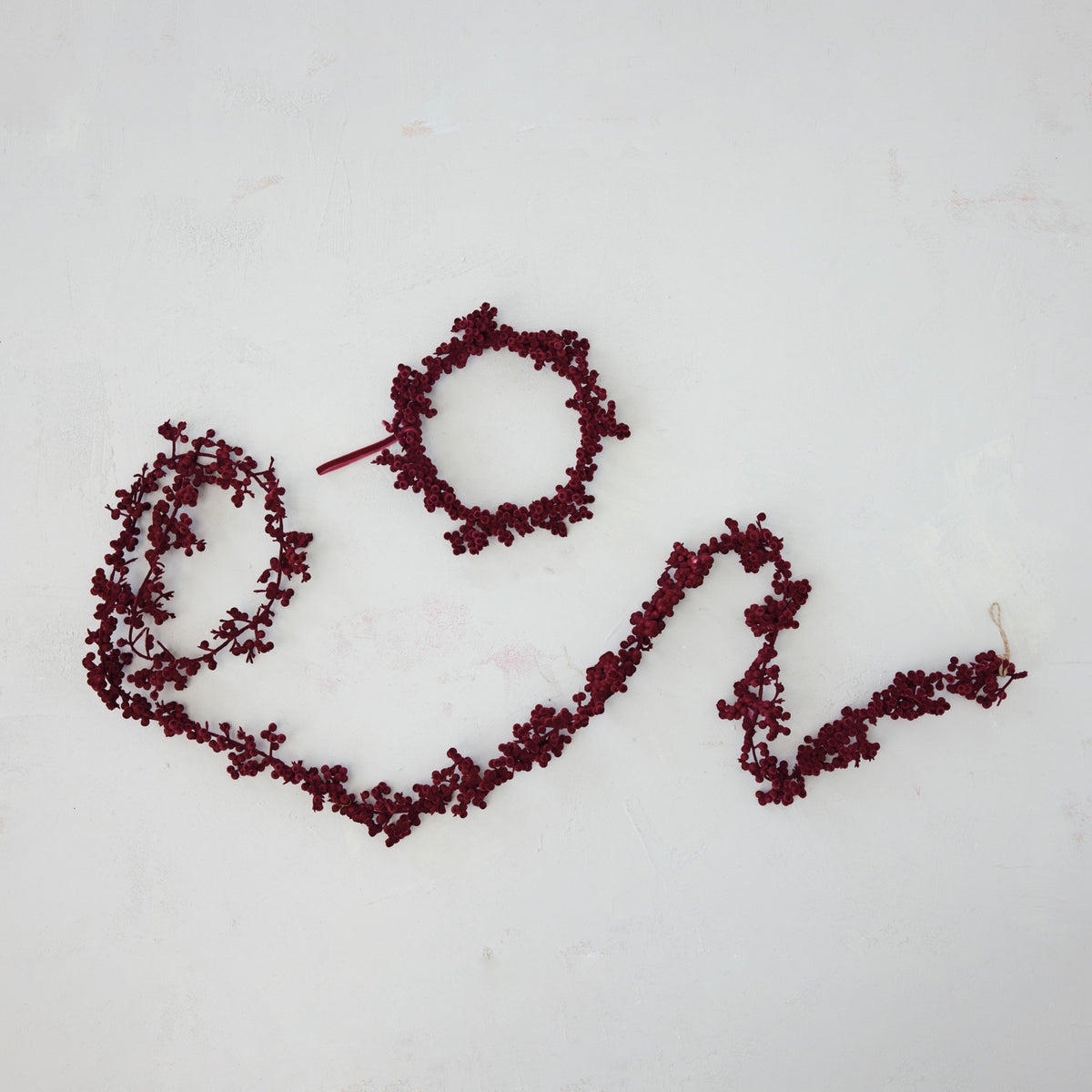 Decorative wreath made of red berries on a white background