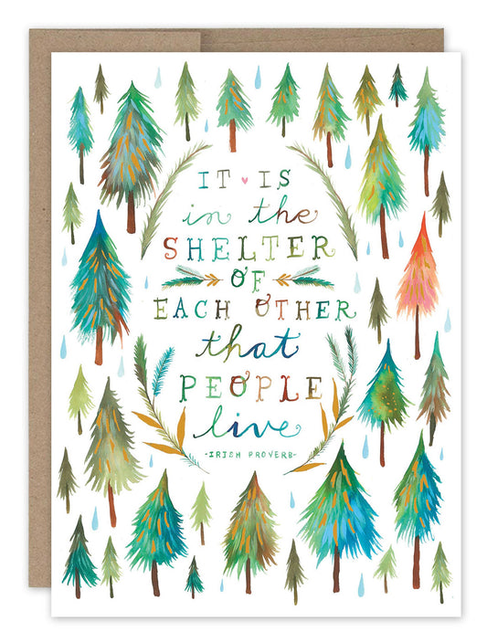 Card with tree pattern and text 'It is in the shelter of each other that people live' on a white background.