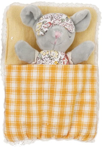 A plush gray mouse toy tucked inside a soft yellow blanket with a yellow-and-white plaid cover, wearing a floral sleep mask and matching floral top.