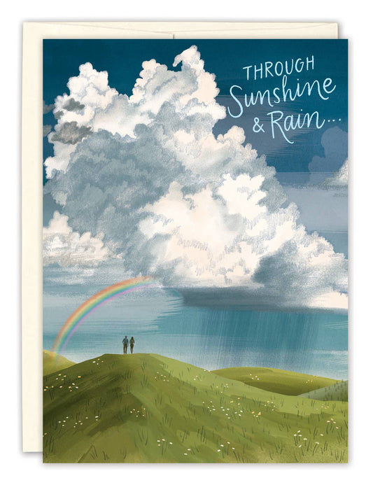 Card with a scenic illustration of a rainbow and clouds, featuring the text 'Through Sunshine & Rain'.