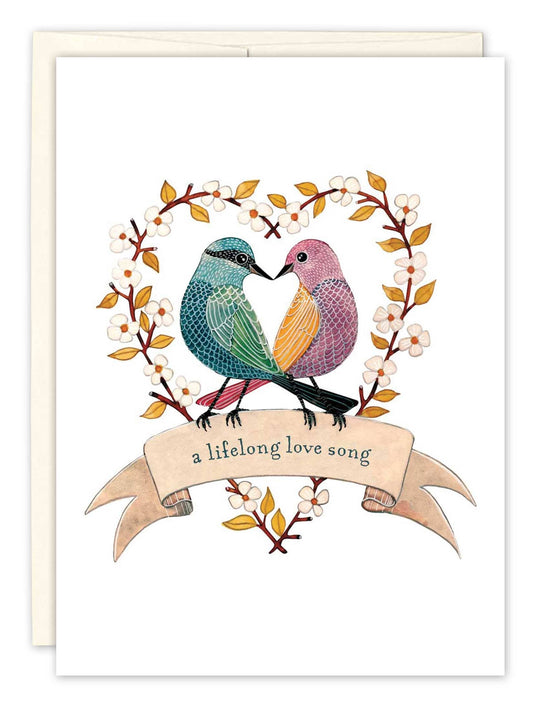 Greeting card with two birds embracing and the text 'a lifelong love song' on a white background.