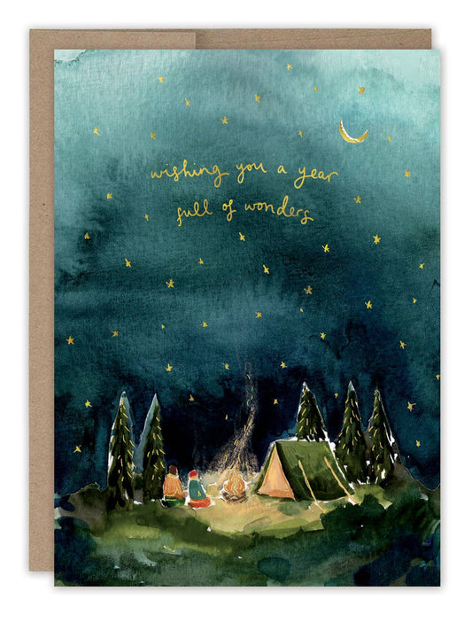 Greeting card with a camping scene under a starry night sky, featuring the text 'Wishing you a year full of wonders'.