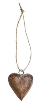 Wooden heart-shaped pendant hanging on a string against a white background