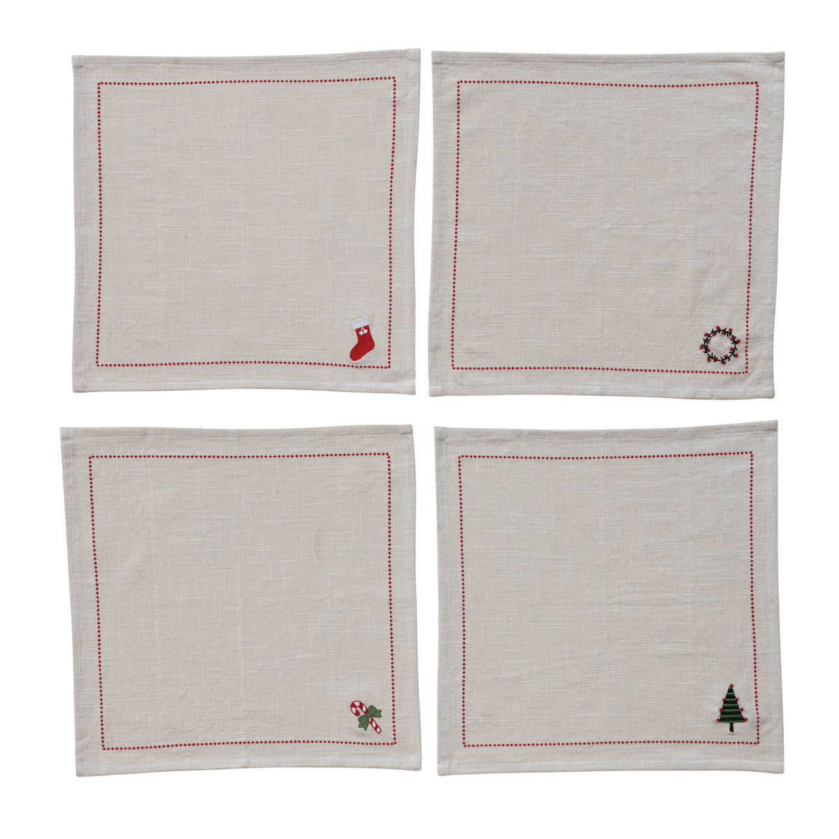 Four beige napkins with embroidered designs on a white background