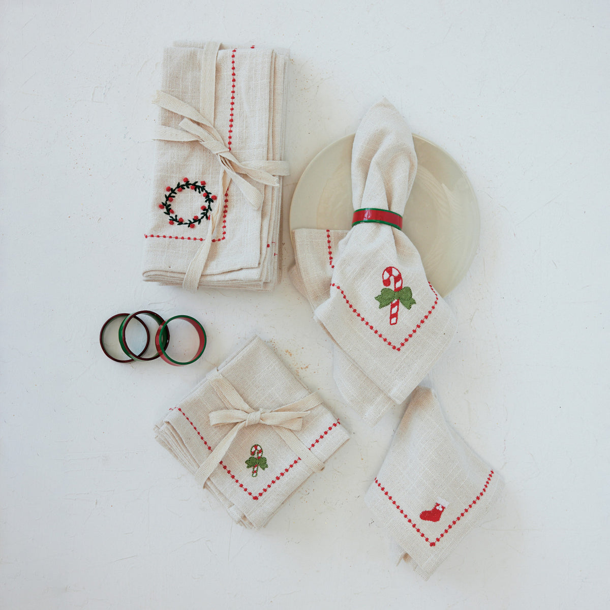 Set of decorative napkins with Christmas designs on a white surface