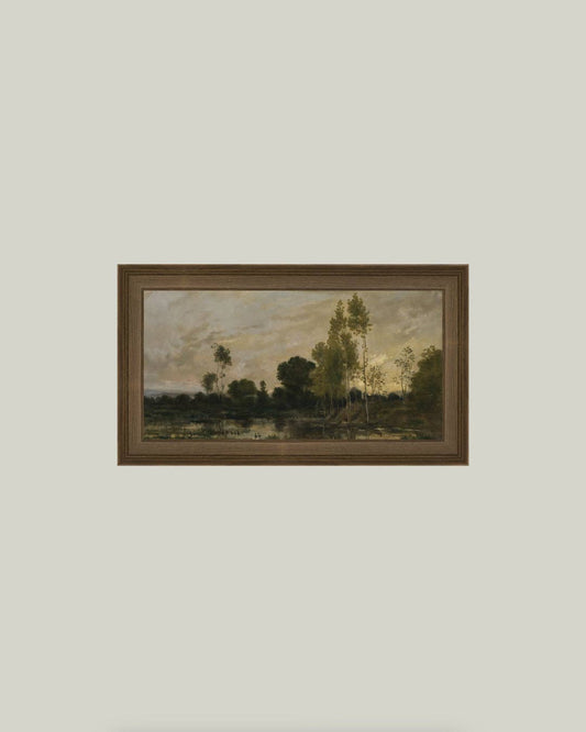Framed painting of a landscape with trees and a body of water.
