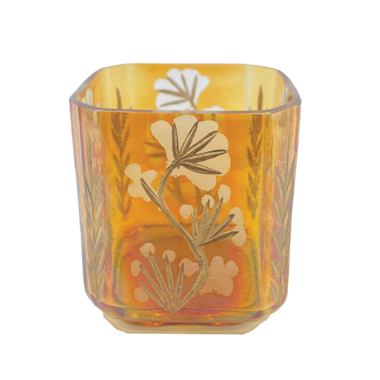 Amber glass votive candle holder with etched botanical design