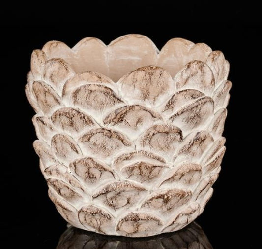 Cement flower pot shaped like a pinecone with textured scales in brown, terracotta, and grey tones, shown empty on a wooden surface.