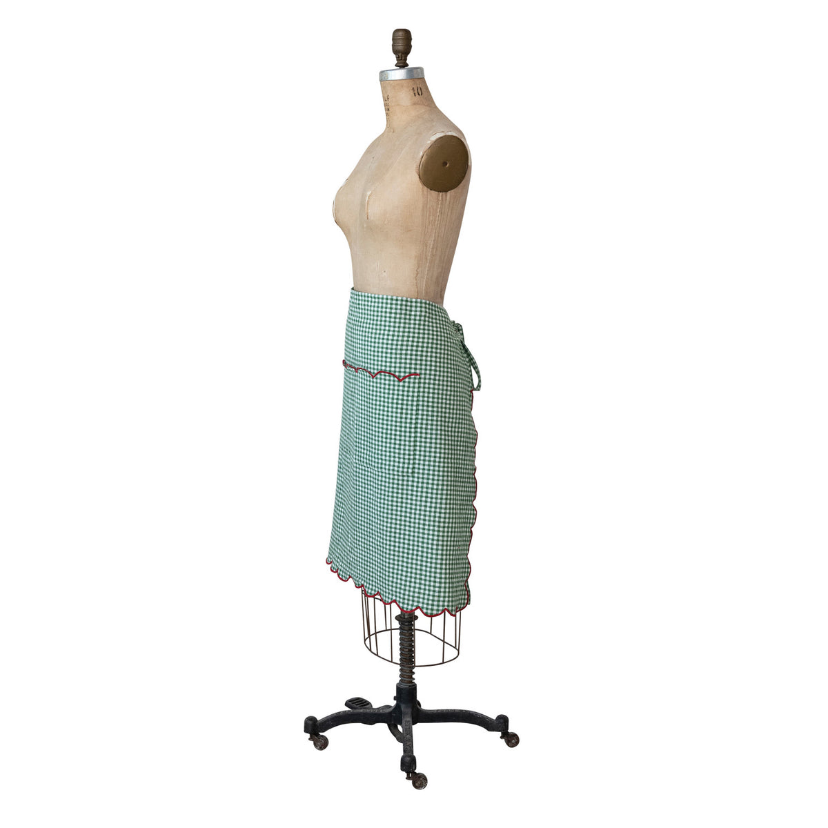 Green gingham scalloped half apron with red stitched trim and adjustable waist ties shown from the front.