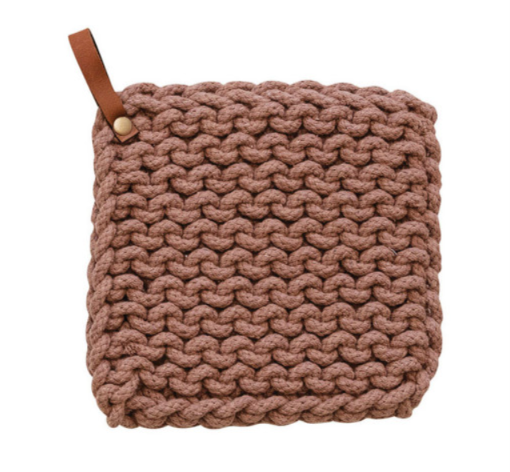 A square, cotton crocheted pot holder in the color mauve with a small brown leather pull tab.