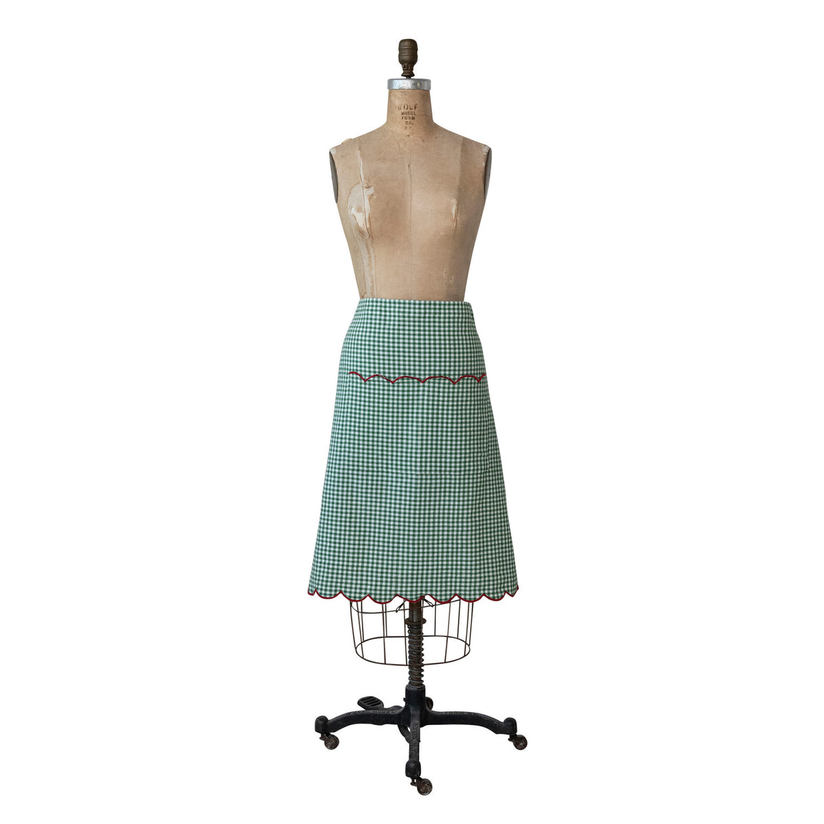 Green gingham cotton half apron with scalloped red trim.