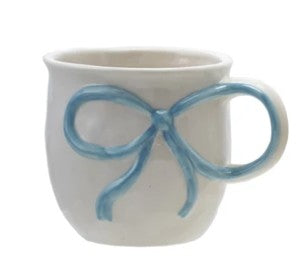 White mug with a blue bow handle on a white background