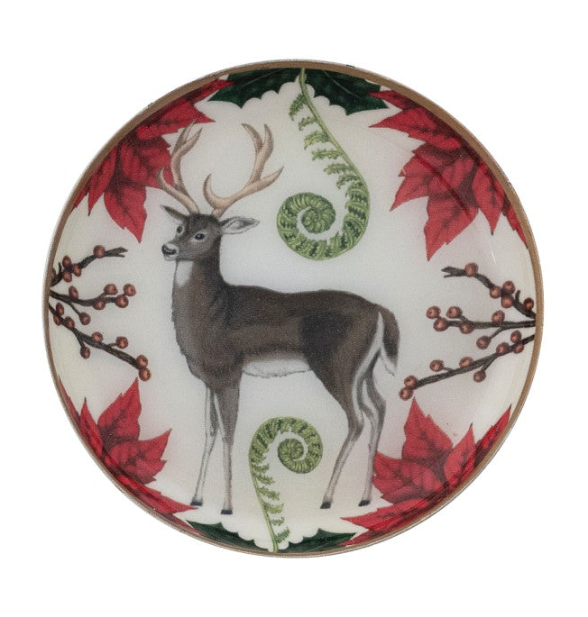 Round enameled metal trinket dish with deer and woodland botanical illustration and gold-toned edge.