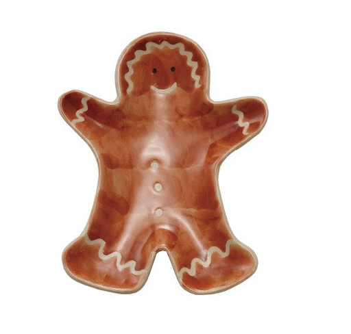 A gingerbread man shaped ceramic trinket dish or bowl with a glossy brown glaze and white icing-style outlines.
