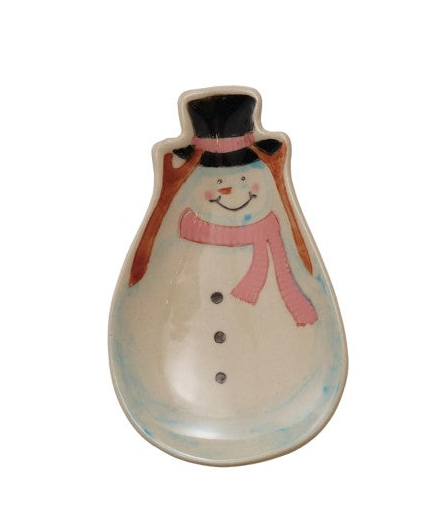A ceramic snowman-shaped trinket dish with a cream-colored body, a pink scarf, a black top hat, and blue accents.