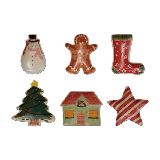 Assorted hand-painted stoneware Christmas trinket dishes shaped like a Christmas tree, cottage, gingerbread man, snowman, star, and stocking.
