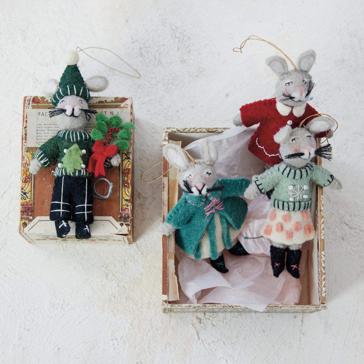 Handmade wool felt Christmas mouse ornaments dressed in colorful winter coats, sweaters, hats, and scarves with embroidered and beaded details.