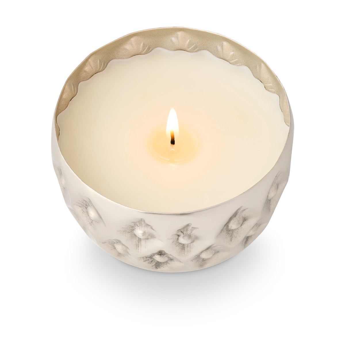 Illume Balsam & Cedar candle in a pale textured pressed-metal vessel with scalloped rim and lit wick.