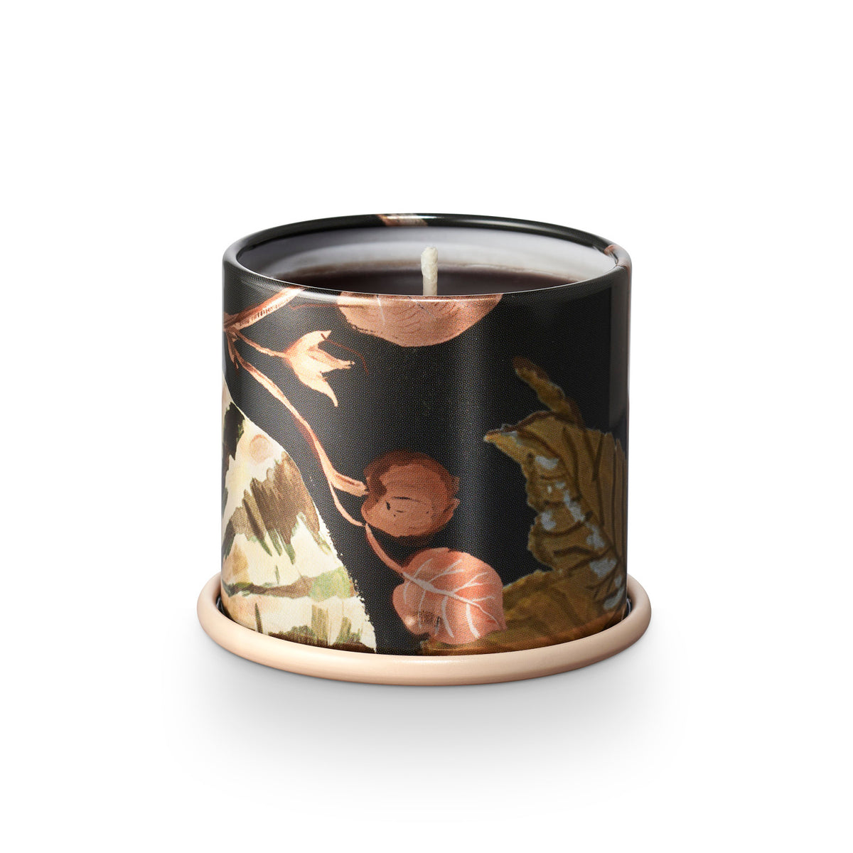 Candle in a decorative container with floral design on a white background